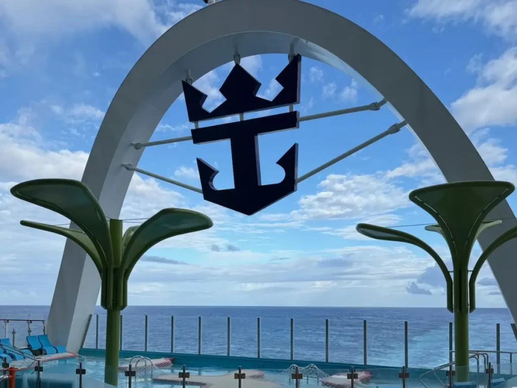 A decorative cruise ship anchor logo emblem mounted outdoors.
