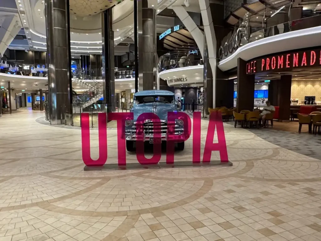 Large, bold red letters spelling out Utopia on a cruise ship deck.
